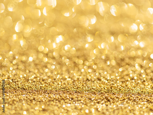 Sparkling golden powder. Festive background.