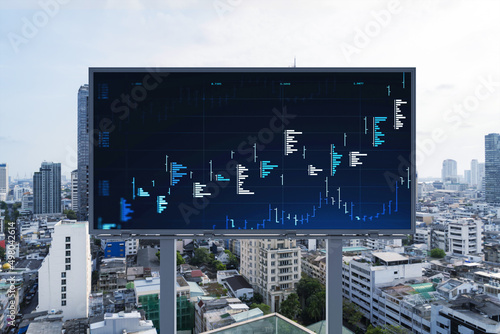 Forex and stock market chart hologram on road billboard over panorama city view of Bangkok. The financial center in Southeast Asia. The concept of international trading.