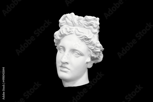 bust head of a woman made of plaster cast isolated on black background. three-quarter position