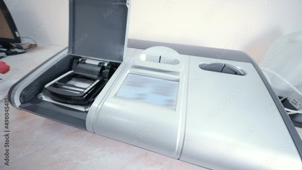 hands of a laboratory worker or nurse in pink rubber gloves working on a modern laboratory analyzer. hands of a laboratory worker or nurse in pink rubber gloves working on a modern laboratory analyzer.