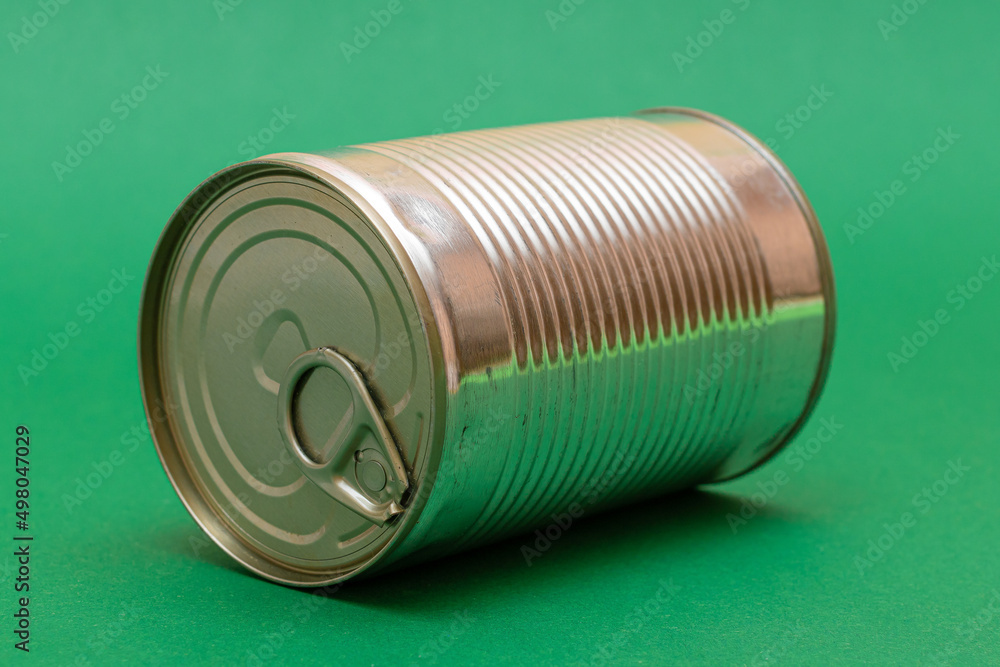 Unopened Tin Can with Blank Edge on Green Background. Canned Food. Aluminum Can for Safe and Long Term Storage of Food. Steel Sealed Food Storage Container Unopened Tin Can with Blank Edge on Green Background. Canned Food. Aluminum Can for Safe and Long Term Storage of Food. Steel Sealed Food Storage Container