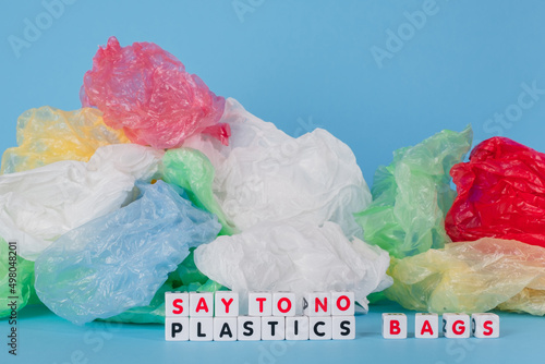 Say to no plastics bags words from cubes on the background of a white plastic bag. Plastic free concept. High quality photo photo