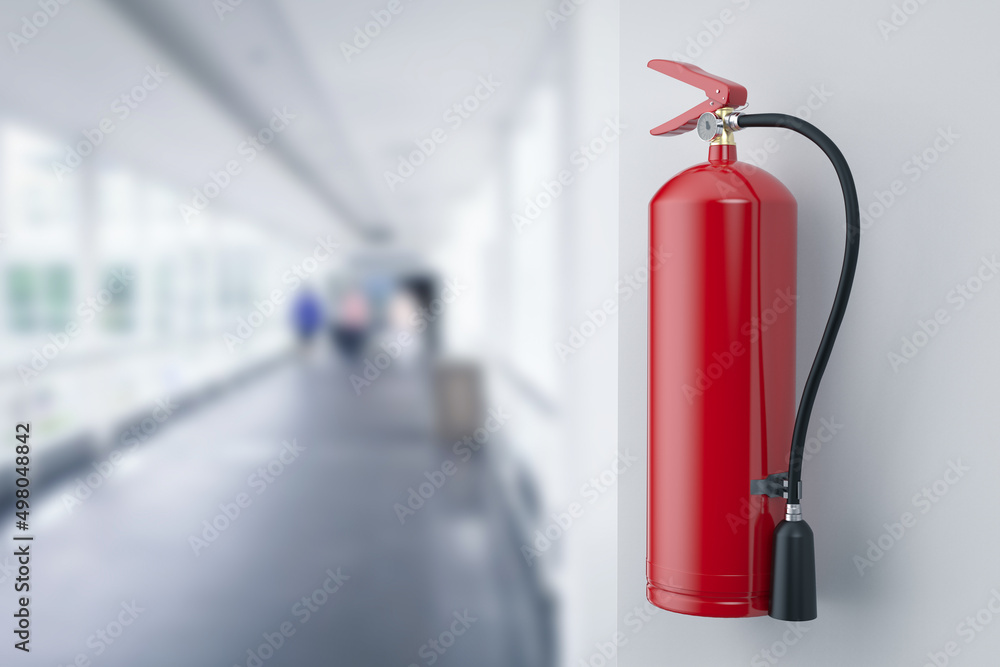 Fire extinguishers hanging on wall in office Fire extinguishers hanging on wall in office