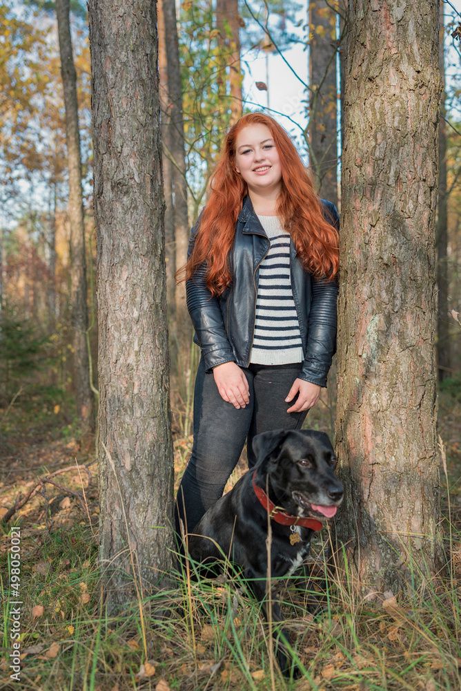 Portrait of a young beautiful red-haired girl in the forest. Portrait of a young beautiful red-haired girl in the forest.