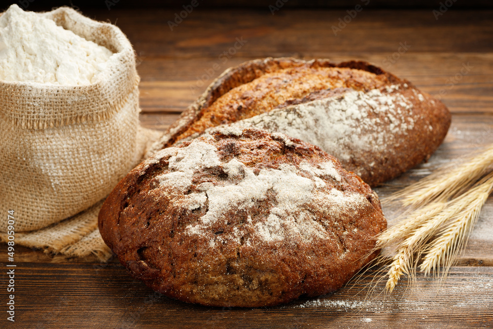 Freshly baked traditional bread on a wooden table. Freshly baked traditional bread on a wooden table.