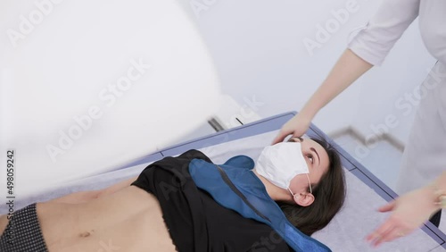 young pretty girl on examination in a modern clinic by densitometry