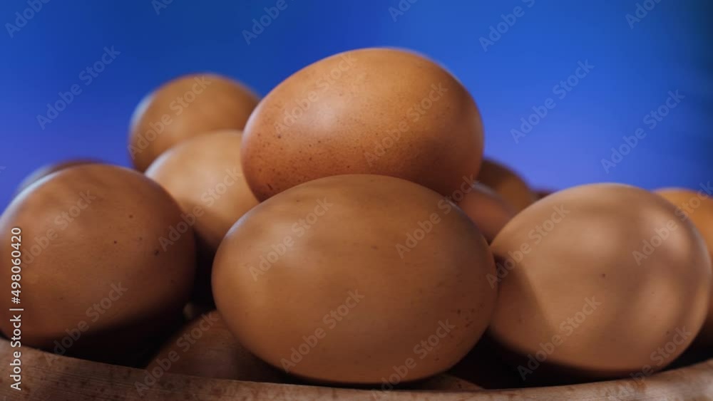 Lots of brown eggs on wooden plate spinning. Fresh chicken raw eggs - Close up, shallow depth. Natural Egg production concept Lots of brown eggs on wooden plate spinning. Fresh chicken raw eggs - Close up, shallow depth. Natural Egg production concept