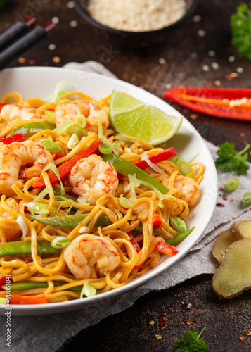 Stir fry noodles with prawns and vegetables in white plate. Healthy asian food