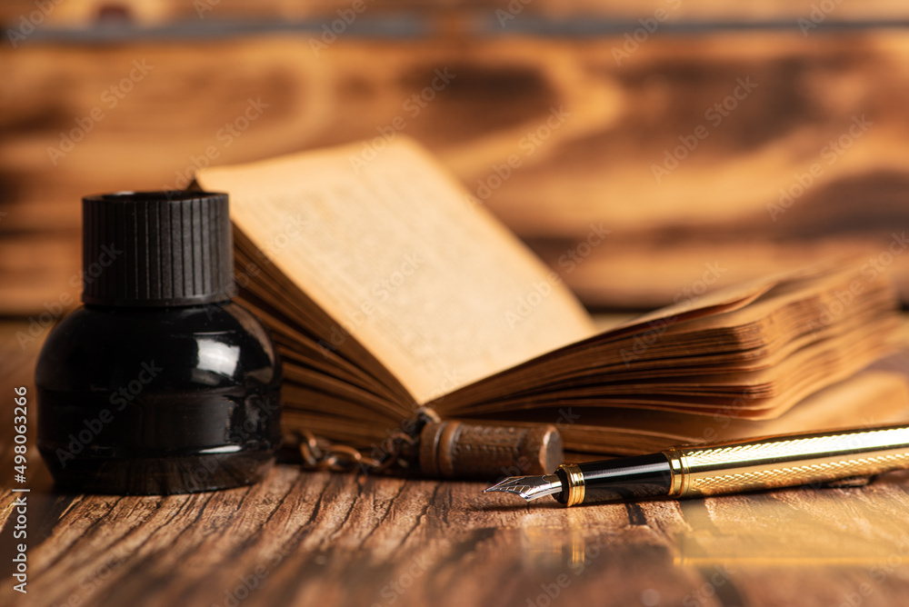 Fountain pen, beautiful fountain pen in an environment with an old clock,  old book, ink among others, selective focus. Stock Photo | Adobe Stock