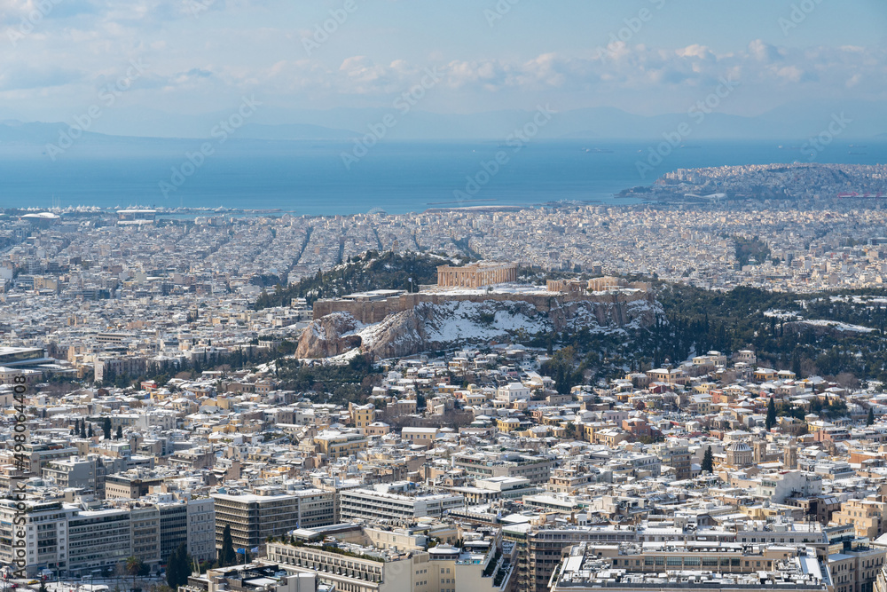 Obraz premium Parthenon temple covered in snow, view from Lycabettus hill after heavy snowfall, Acropolis, Athens