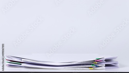 4K Footage video Stop motion of stack paper falling on white background, paperless concept in office.