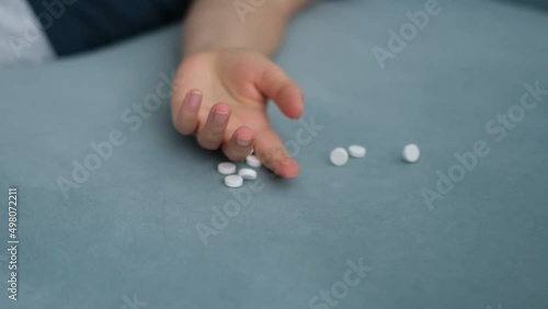 defocus woman falls dropping pills, pill overdose. Commit suicide, Drug overdose concept. Closeup Slow motion video photo