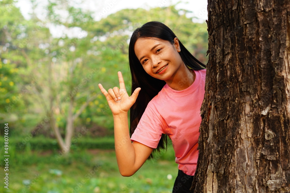 Asian women embrace trees with love, concept of love for the world Asian women embrace trees with love, concept of love for the world