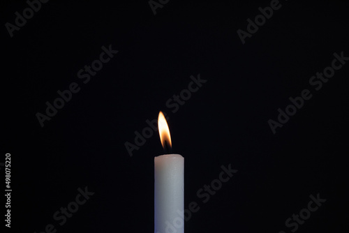 candle on a black background. candle fire in the dark. candle in the dark. burning candle in the dark