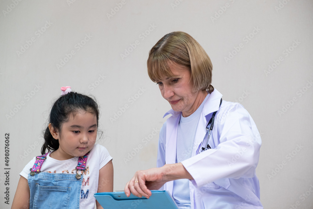 Young Asian girl doing high five with doctor while get medical care service in the hospital. Medical service for young people, kids or children medical service. Young Asian girl doing high five with doctor while get medical care service in the hospital. Medical service for young people, kids or children medical service.