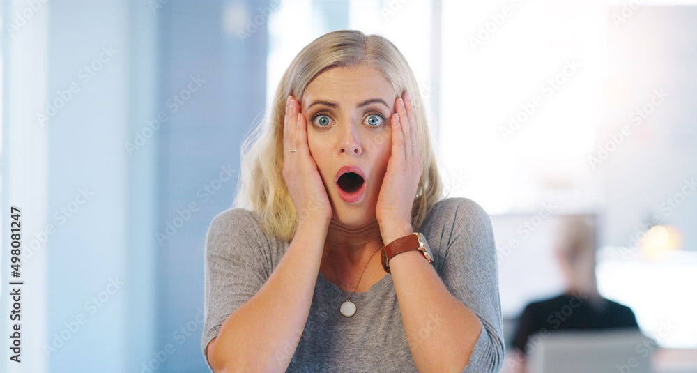 I messed up big time. Portrait of a confident young businesswoman looking surprised and holding her hands close to her face inside of the office. I messed up big time. Portrait of a confident young businesswoman looking surprised and holding her hands close to her face inside of the office.
