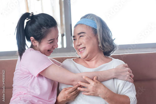 Asian young woman take care and warn hug mother, she is very happy and smile in living room.