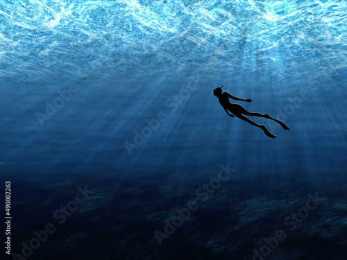 man swims under water in rays of light
