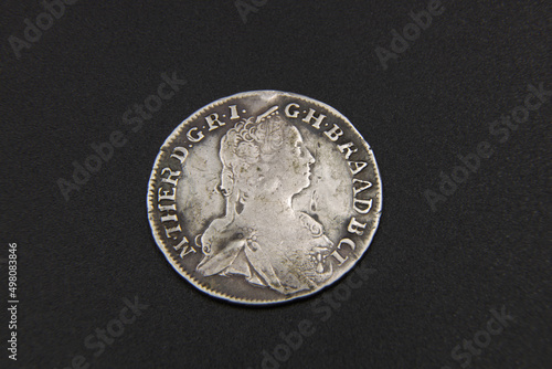 Old Austrian silver coin on black background