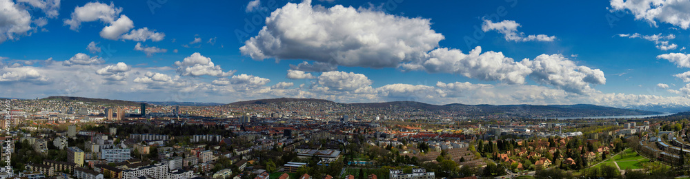 Large panorama of the city of Zurich in sunny weather with white clouds