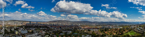 Large panorama of the city of Zurich in sunny weather with white clouds
