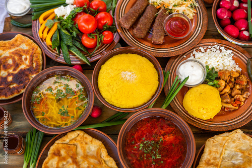 Foto Homemade Romanian Food with 
pies, polenta, borscht, vegetables, fish, meat, stew, cheese and wine