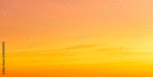 orange sunset sky in the evening on gold hour sky background  photo