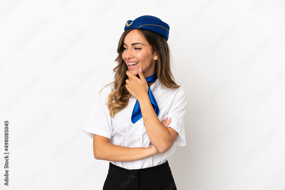 Airplane stewardess over isolated white background looking to the side Airplane stewardess over isolated white background looking to the side