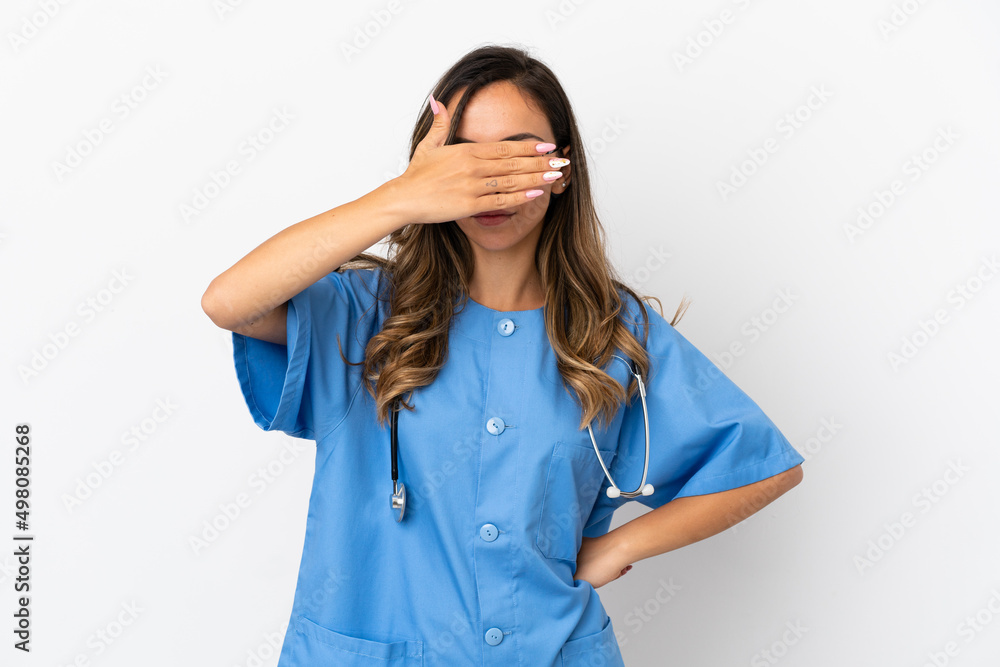 Young surgeon doctor woman over isolated white wall covering eyes by hands. Do not want to see something Young surgeon doctor woman over isolated white wall covering eyes by hands. Do not want to see something