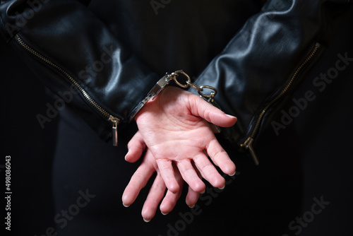 Arrest, protection from crime and law violation. Handcuff criminal woman hands close up. © Rawf8