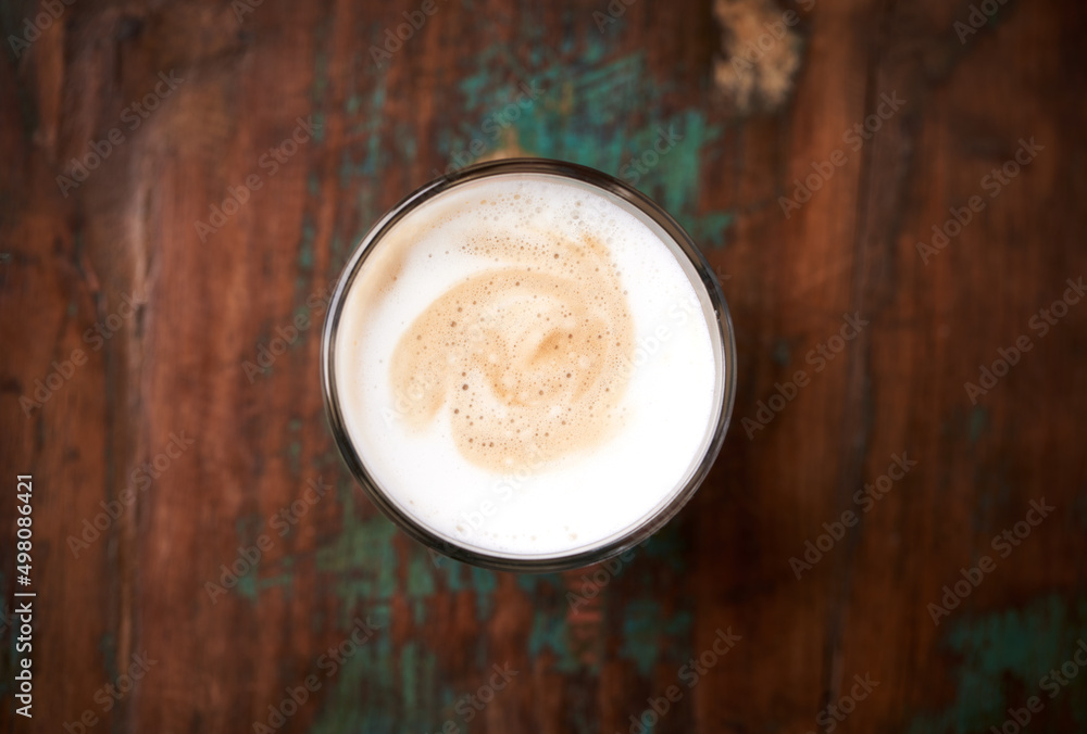 Coffee with milk on rustic wooden background. Soft focus. Top view. Close up. Copy space. Coffee with milk on rustic wooden background. Soft focus. Top view. Close up. Copy space.