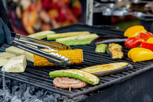 Vegetables bbq. Slices of vegetables and corn are grilled outdoors. Vegetarian picnic