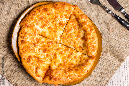 khachapuri with cheese, megrelian khachapuri, georgian cuisine on wooden table  top view photo