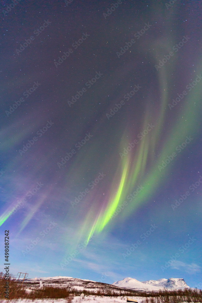 Abisko, Aurora Borealis in Lapland. Sweden lights in the sky full of stars. Land of the Sami people. 
Solar wind colors