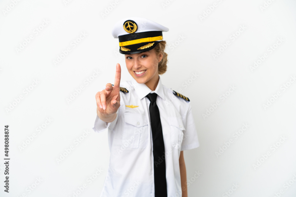 Airplane blonde woman pilot isolated on white background showing and lifting a finger Airplane blonde woman pilot isolated on white background showing and lifting a finger
