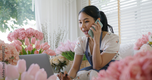 Asia people young Gen Z girl SME owner smile happy work at home office talk on mobile sell product at modern florist gift shop. Online digital marketplace web sale page telesale in social media. photo