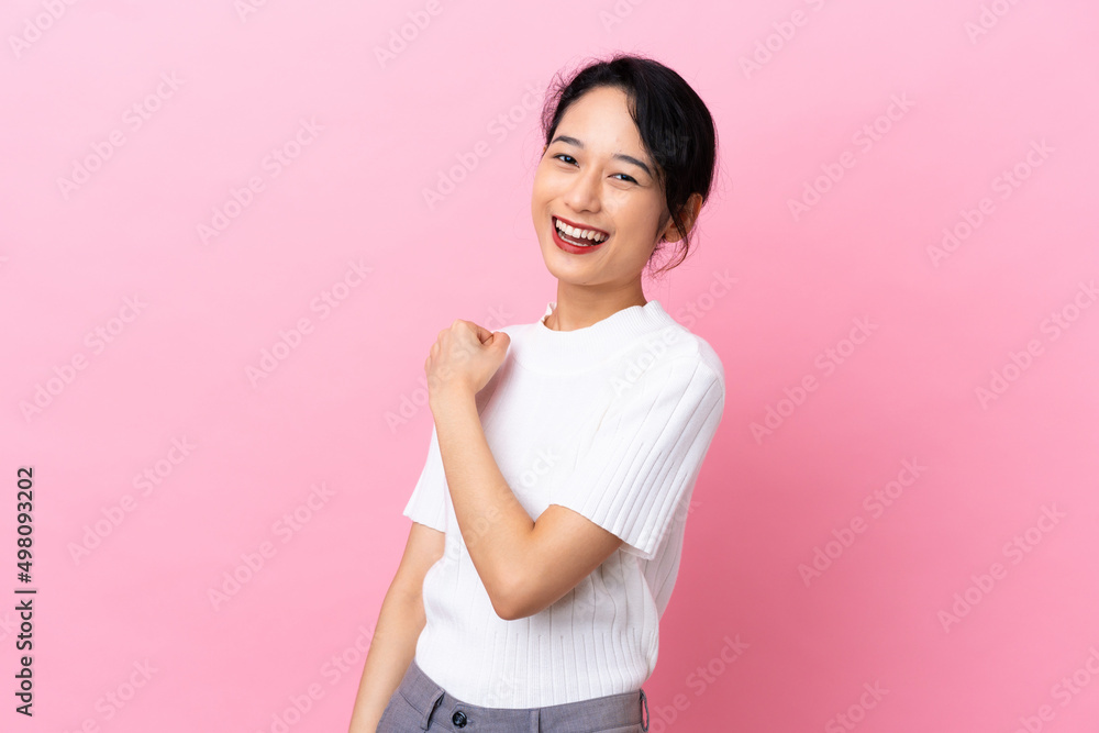 Young Vietnamese woman isolated on pink background celebrating a victory Young Vietnamese woman isolated on pink background celebrating a victory