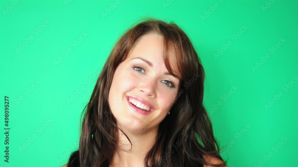 Young woman is looking at the camera with a happy and smiling expression Young woman is looking at the camera with a happy and smiling expression
