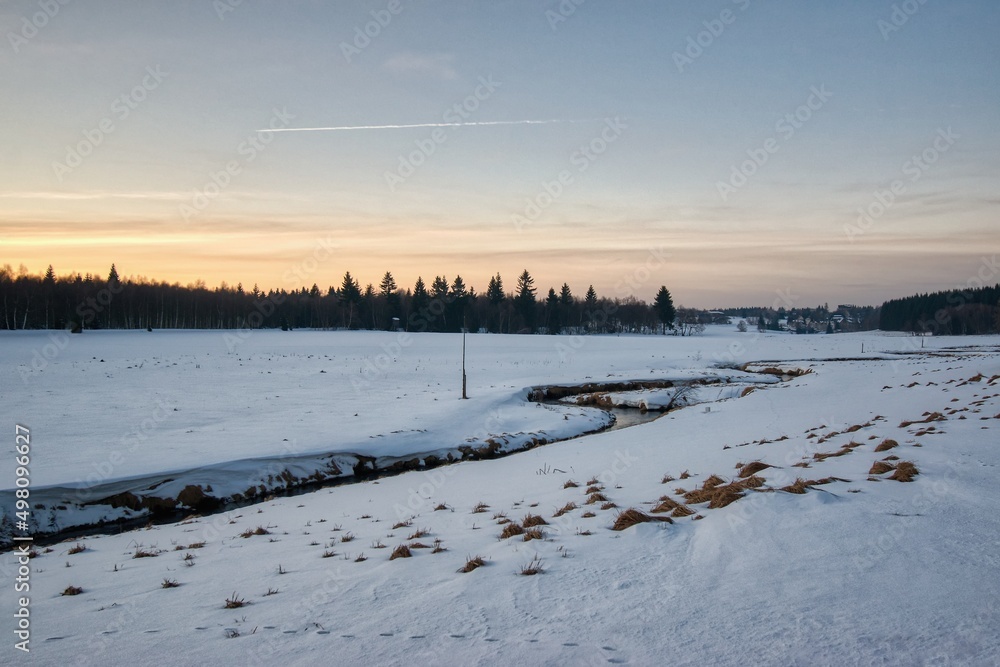 Reitzenhain, Germany - February 13, 2022: sunset in Ore mountains at snowy winter Reitzenhain, Germany - February 13, 2022: sunset in Ore mountains at snowy winter