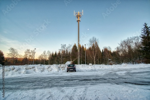 Hora Svateho Sebestiana, Czechia - February 13, 2022: snowy parking place with black car Opel Astra H in winter photo