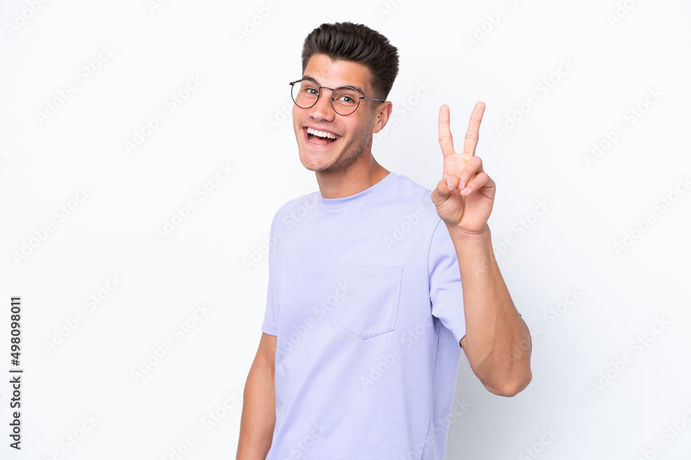Young caucasian man isolated on white background smiling and showing victory sign Young caucasian man isolated on white background smiling and showing victory sign