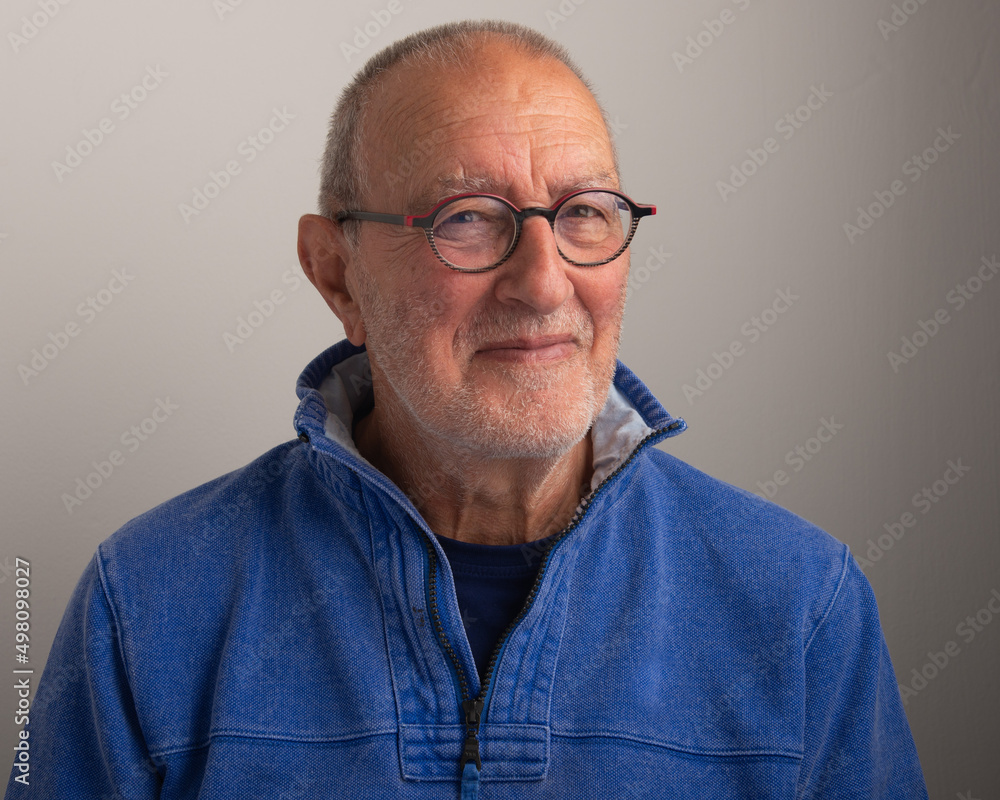 Close up portrait of a senior man on a grey background Close up portrait of a senior man on a grey background