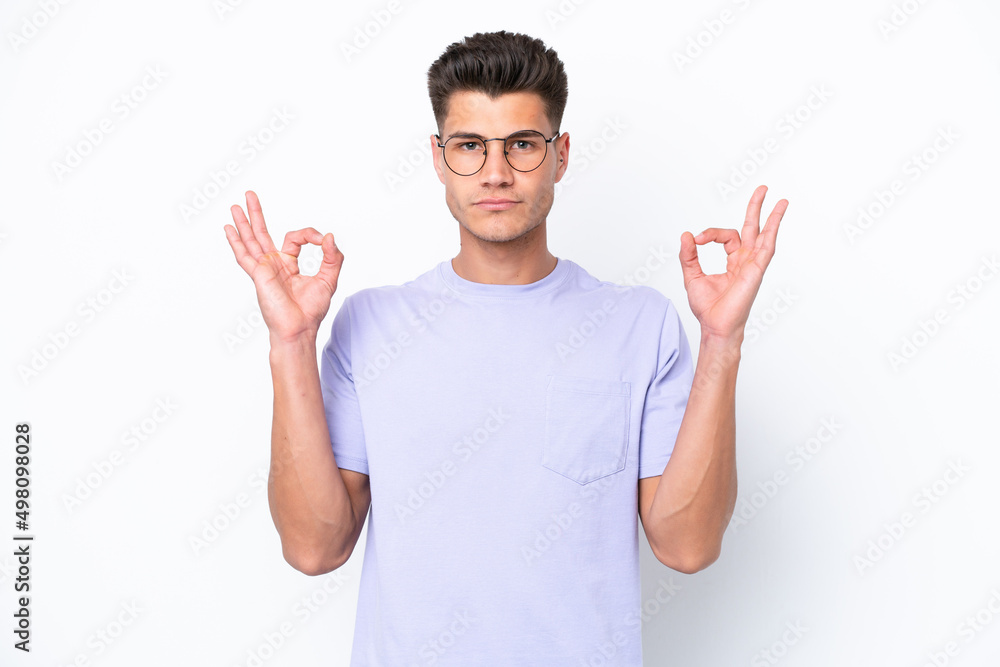 Young caucasian man isolated on white background in zen pose Young caucasian man isolated on white background in zen pose