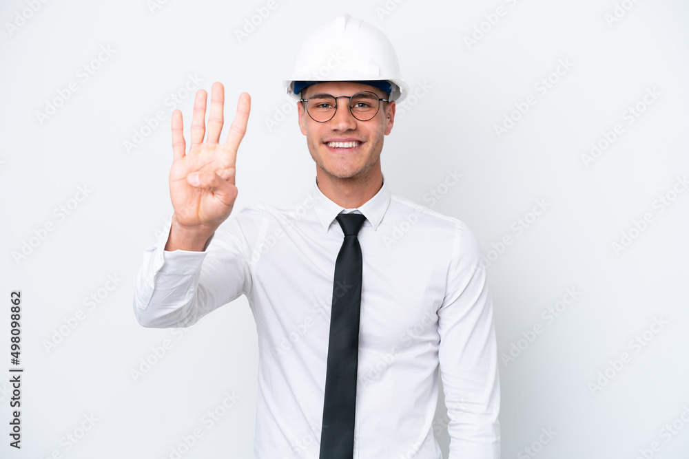 Young architect caucasian man with helmet and holding blueprints isolated on white background happy and counting four with fingers