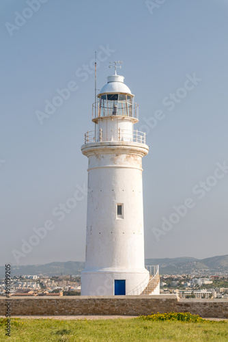 Paphos lighthouse on the Mediterranean sea coast. White lighthouse in archeological park in Paphos city.