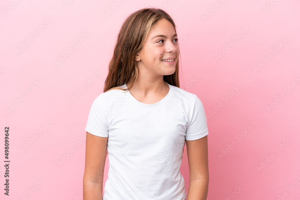 Little caucasian girl isolated on pink background looking side Little caucasian girl isolated on pink background looking side