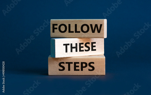 Follow these steps symbol. Concept words Follow these steps on wooden blocks. Beautiful grey background. Business and follow these steps concept. Copy space. © Dzmitry