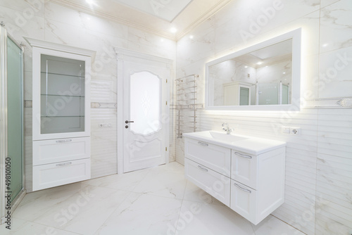 bathroom interior in light tone with mirror and shower