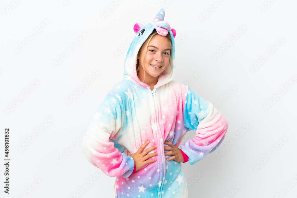 Little girl with unicorn pajamas isolated on white background posing with arms at hip and smiling Little girl with unicorn pajamas isolated on white background posing with arms at hip and smiling