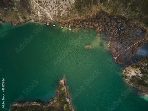 Aerial drone view Basalt columns Amazing industrial landscape, on Emerald lake in a flooded quarry, opencast mine. Open pit mine with lake, travel Ukraine.